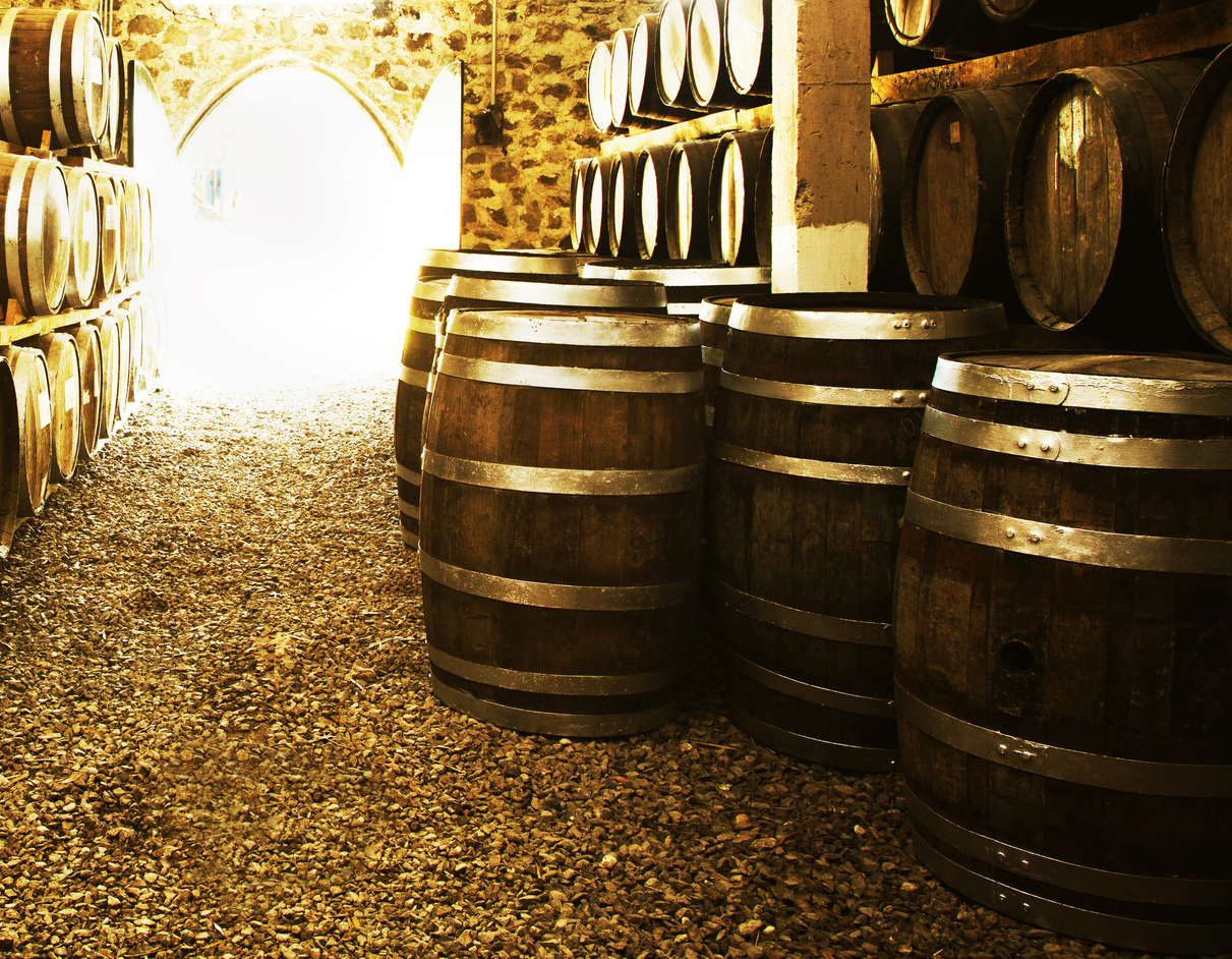 Wine barrels stacked in the old cellar of the winery.